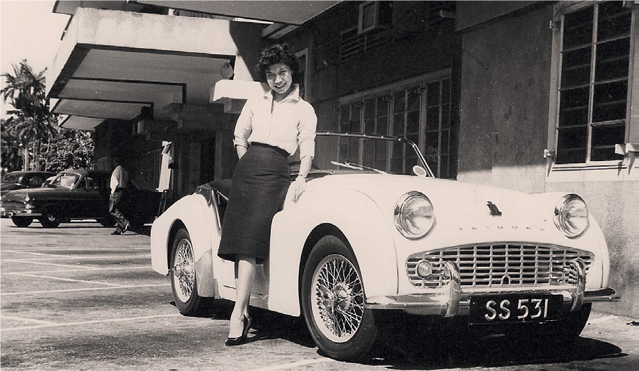 Former Grand Prix champion driver and fashion pioneer Eunice Wong and her favourite Triumph sports car, late 1950s. Courtesy of Phila Mae Wong.